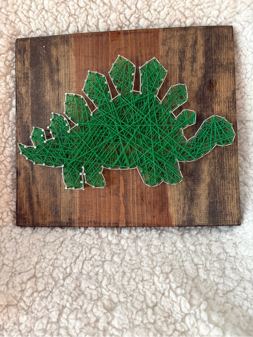 Green Stegosaurus String Art on Stained Wood